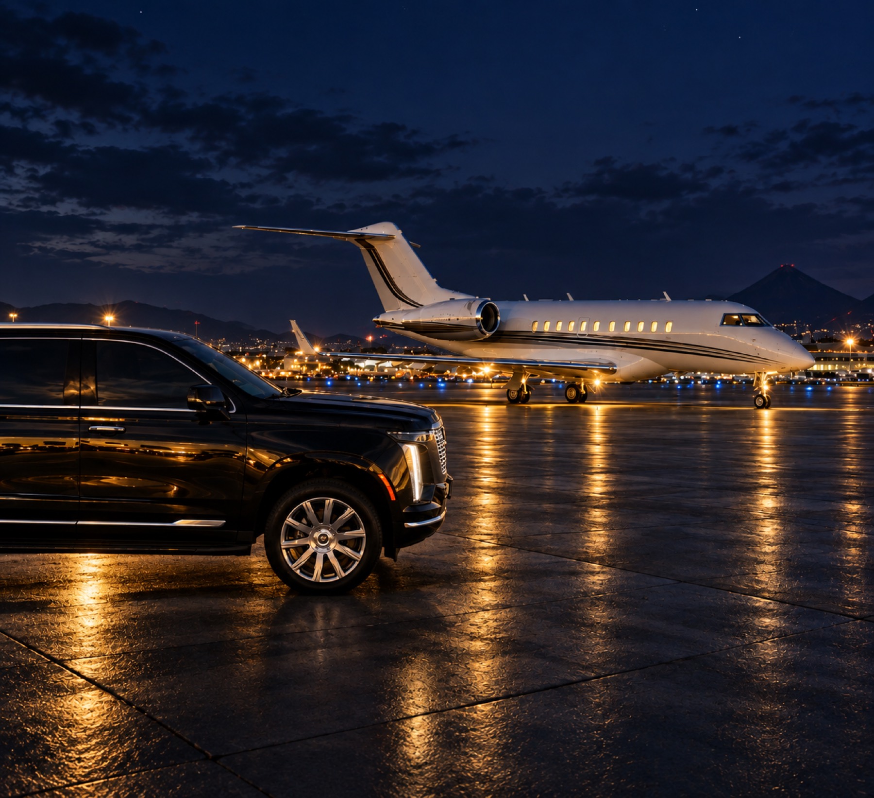 A black Elite Hosts SUV waiting beside a private jet on the tarmac at night